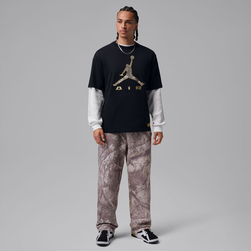 Men's black Air graphic tee worn with gray camo pants, crew neck short sleeves