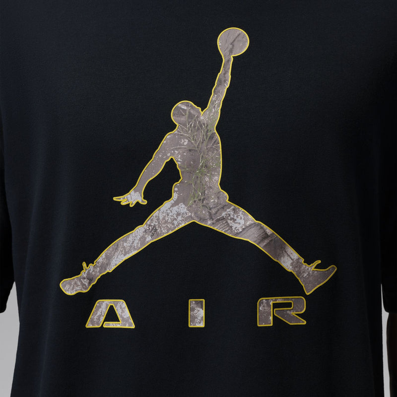 Black tee close-up of gold and gray Jumpman Air graphic across chest