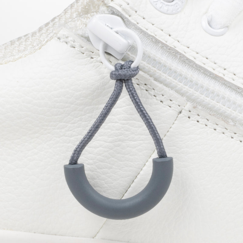 Charcoal loop zipper pull attached to a white sneaker