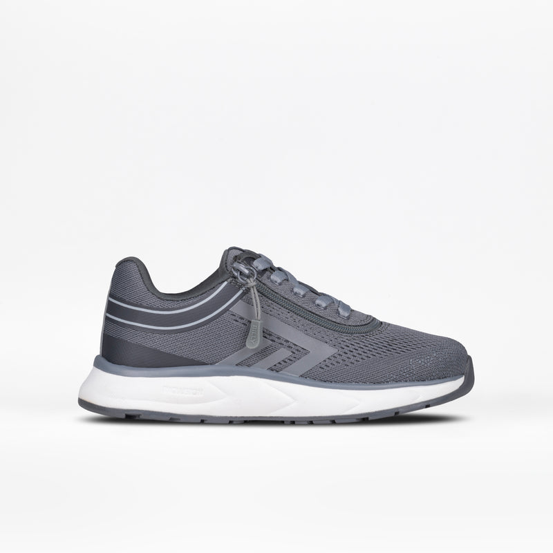 The Charcoal BILLY Sport Inclusion by BILLY Footwear, a kids’ sneaker with mesh fabric, gray laces, and a white sole, is displayed in profile on a plain white background.