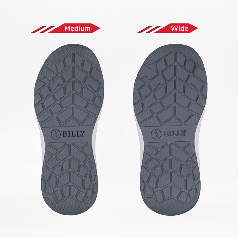 Two gray soles from the Charcoal BILLY Sport Inclusion kids sneakers by BILLY Footwear are shown side by side. The Medium sole is narrower while the Wide sole is broader. Both have similar tread patterns and suit adaptive footwear needs.