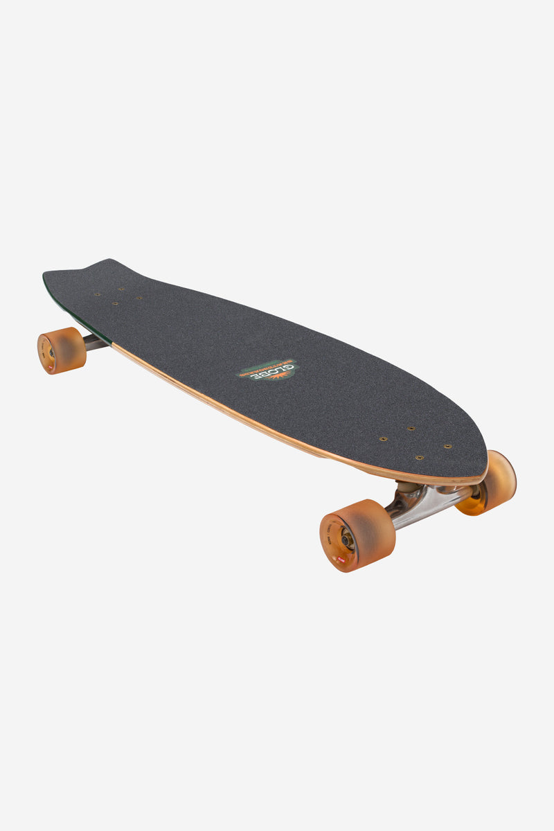 Angled top view of Chromantic Beach Bum 33 cruiser showing dark grip tape and orange wheels.