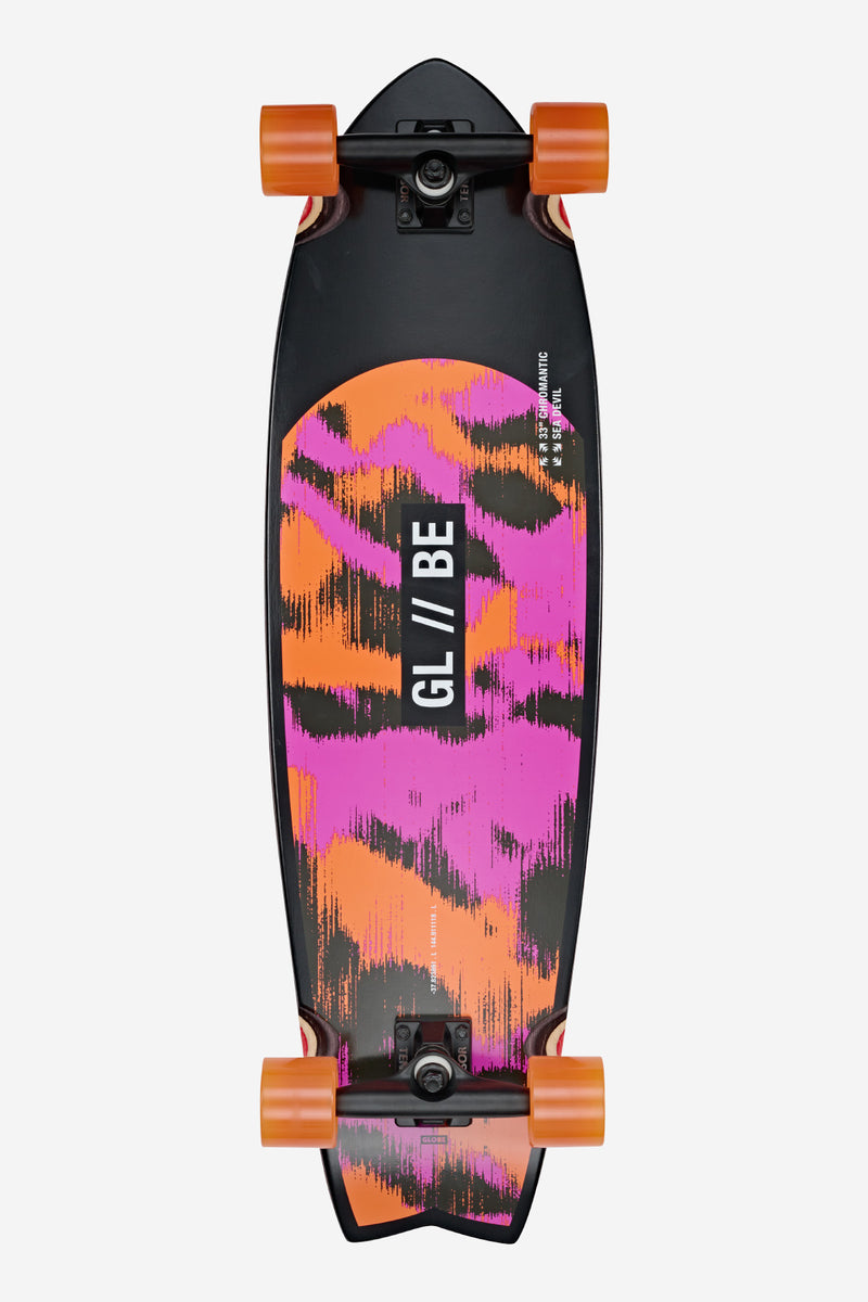 Top-down view of Chromantic Cruiserboard 33 Sea Devil with black deck, vivid orange and pink graphic, and orange wheels.