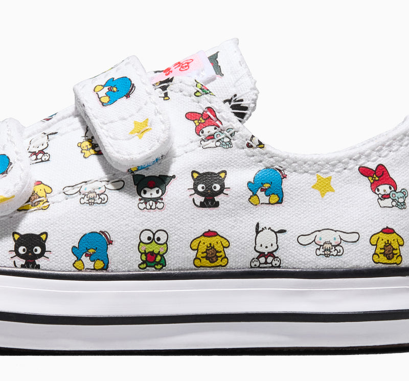 Toddler sneaker upper close-up, white canvas with multicolor character print