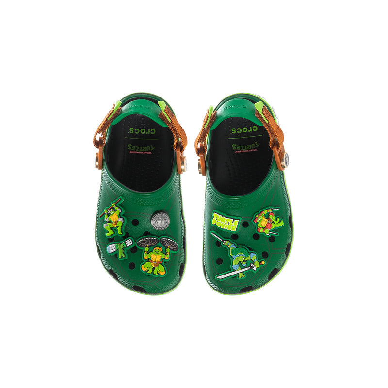 Kids green clog pair view with TMNT prints on toe and strap detail
