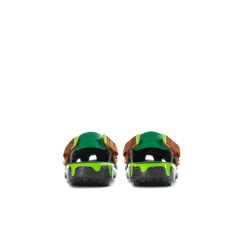 Kids green clog with TMNT prints, adjustable brown strap, black heel