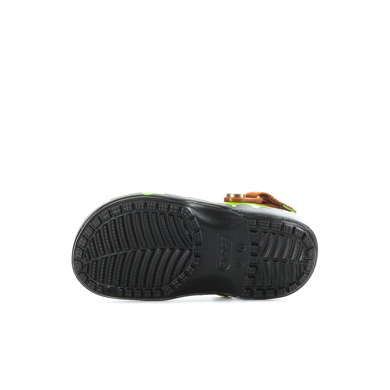 Kids clog outsole view, black textured tread with green upper and brown strap