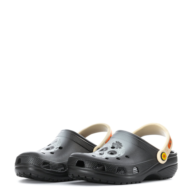 Pair of black clogs with perforated uppers and cream-orange side strap