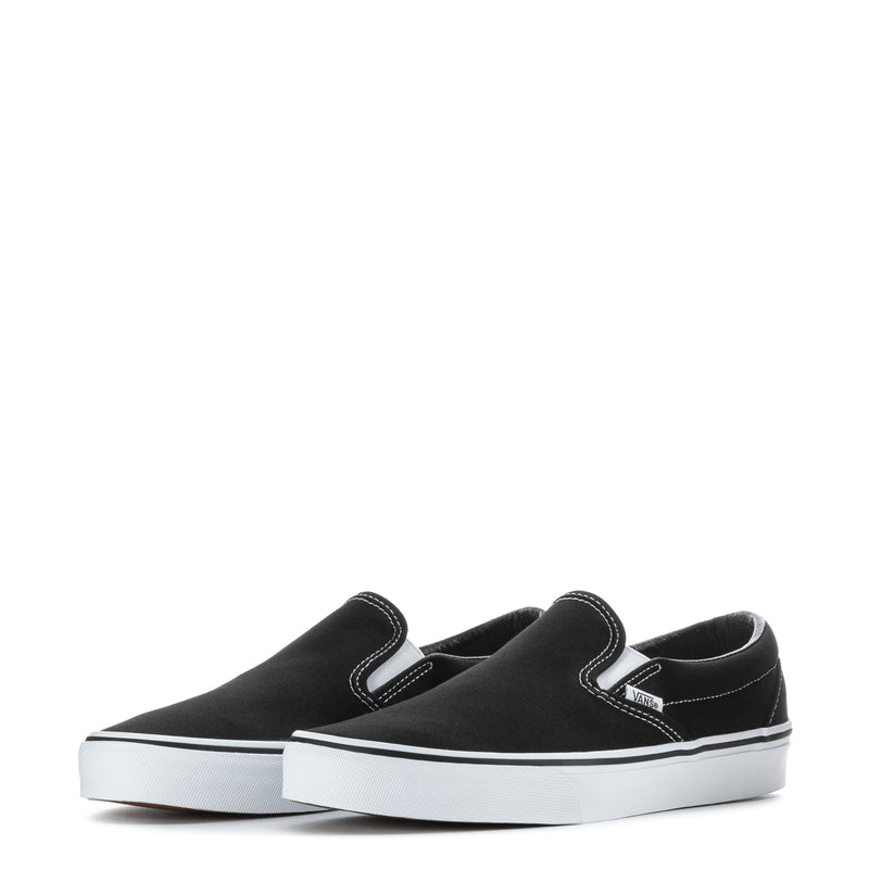 Pair of black slip-on sneakers with white soles and V logo on the side