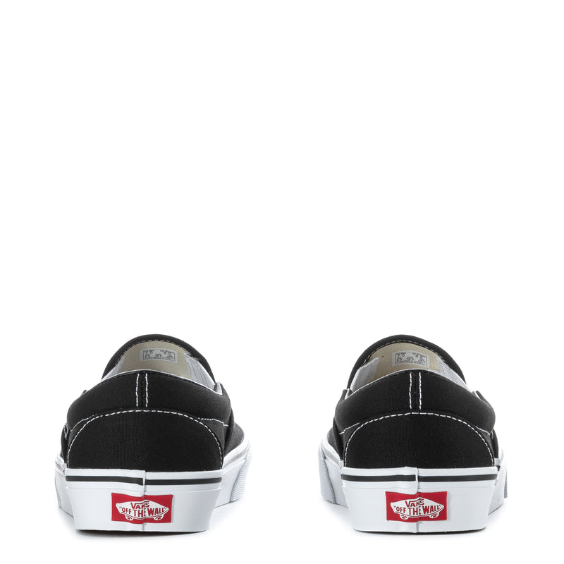 Black slip-on sneakers with white heel tab and Vans heel logo patches