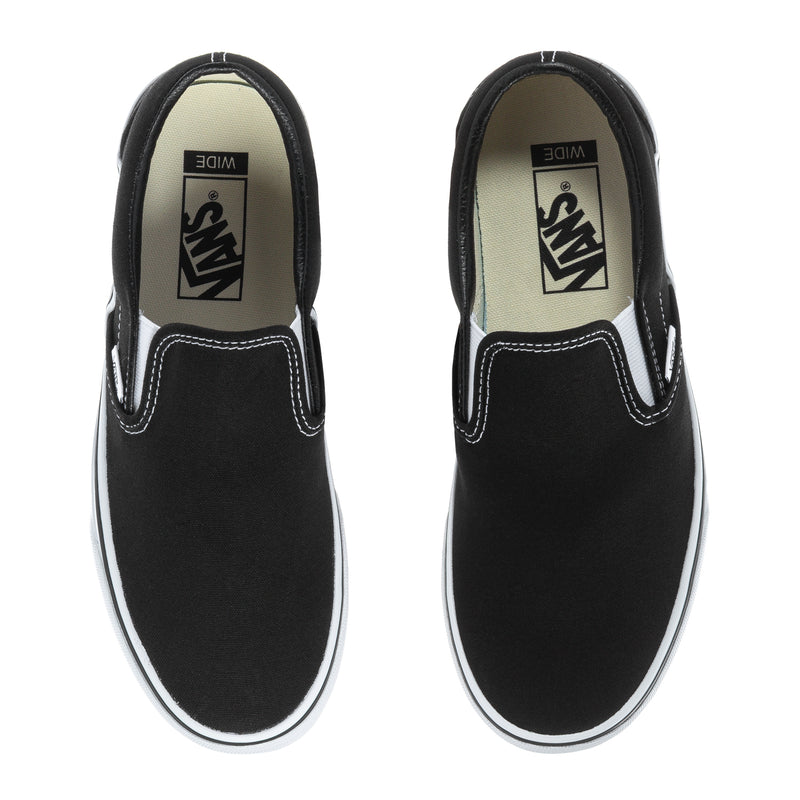 Black slip-on sneakers with contrast stitching and white interior tongue logo