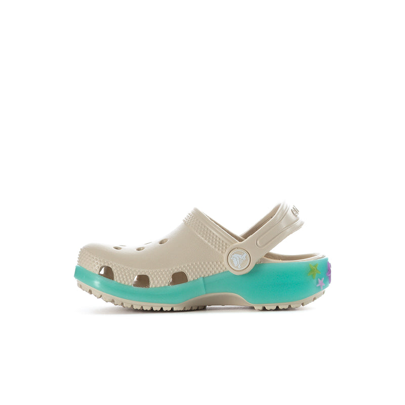 Toddler cream clog with adjustable strap, teal sole, and decorative front charm