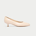 Nude-colored kitten heel shoe on a light gray background
