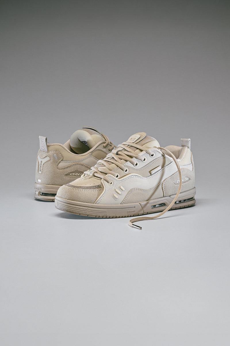 Pair of CT-4 Grey skate shoes with undone laces against a neutral background.