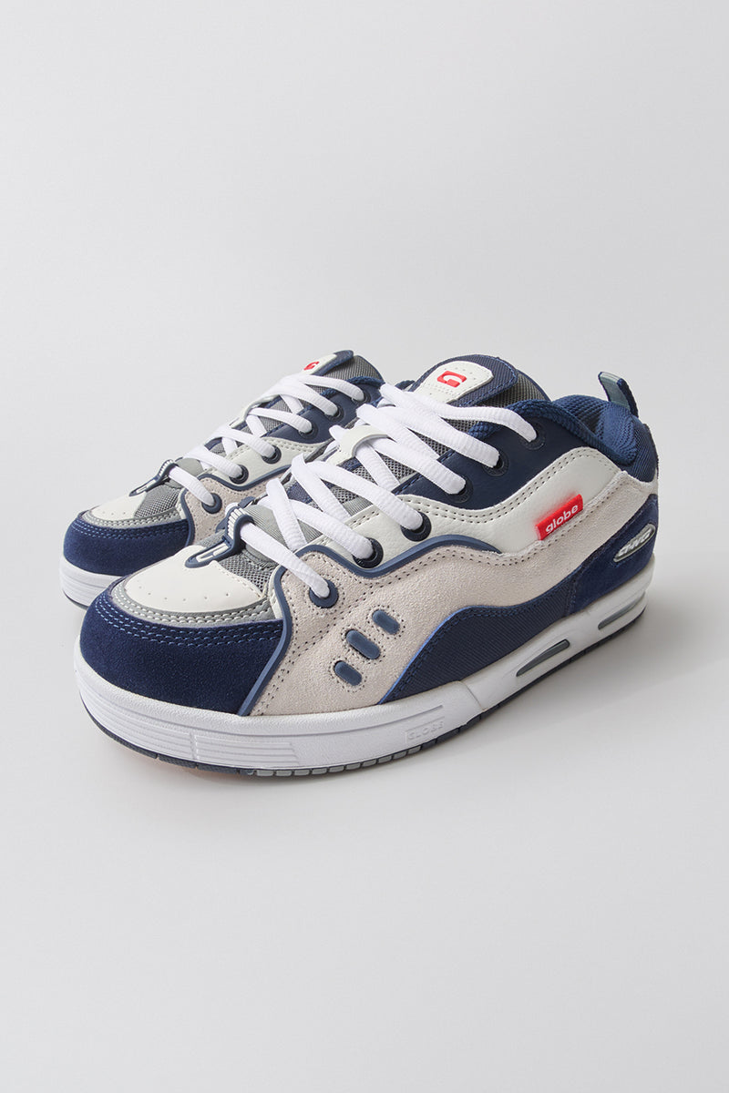 Pair of CT-4 skate shoes in white and navy shown from a low angle