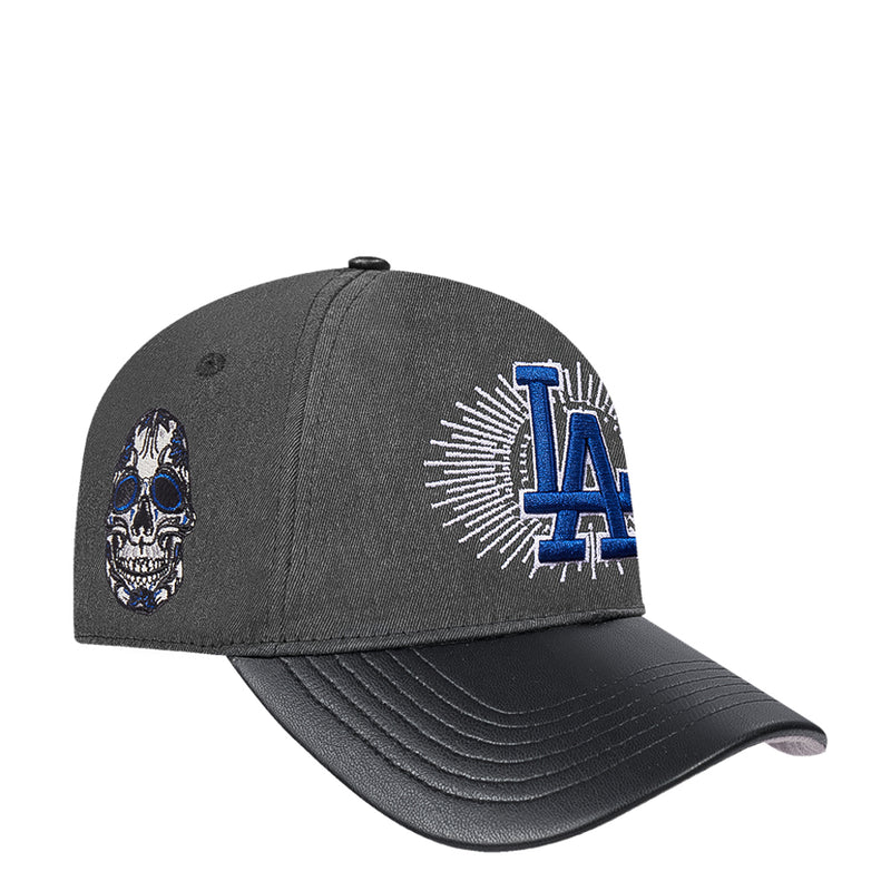 Black washed strapback cap with left skull emblem and blue LA logo on front