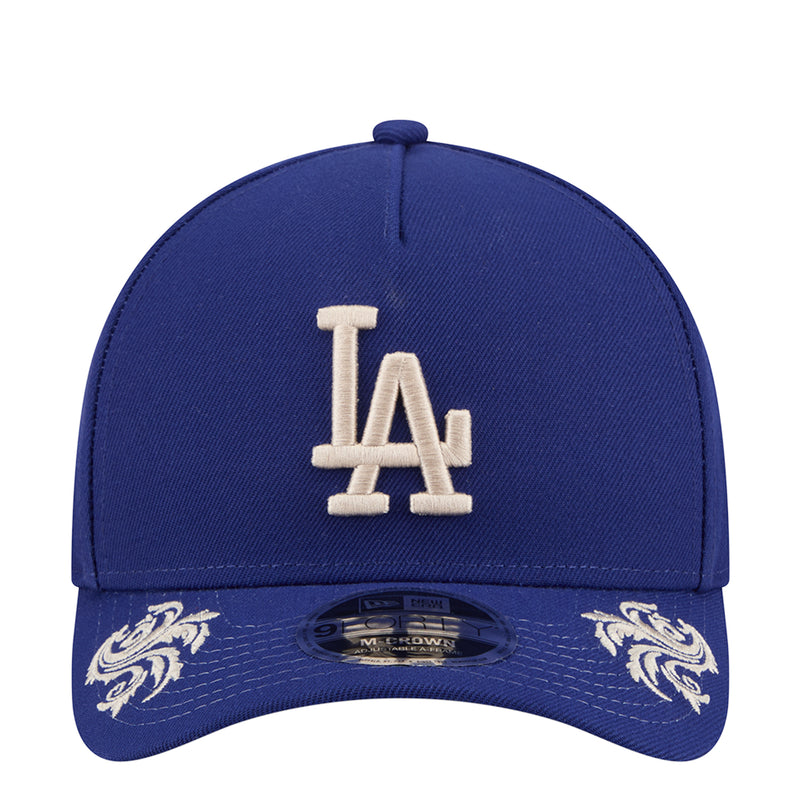 Blue baseball cap with white LA logo front and embroidered side script accents