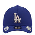 Blue baseball cap with white LA logo front and embroidered side script accents