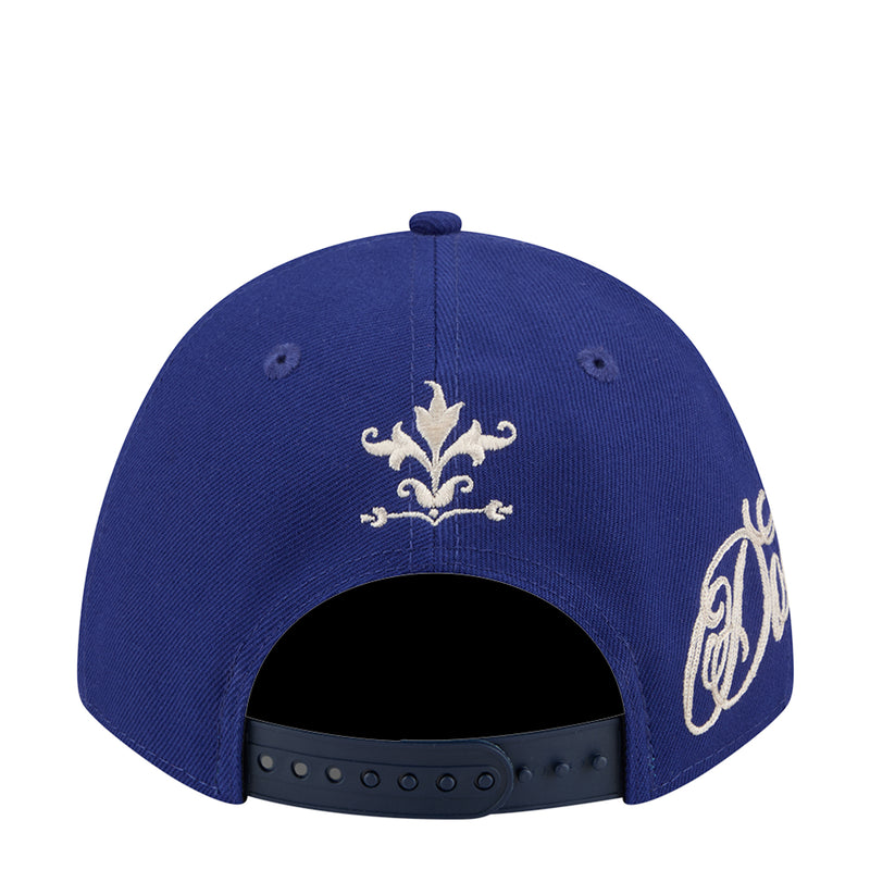 Blue baseball cap top view with embroidered fleur-de-lis and script side graphics