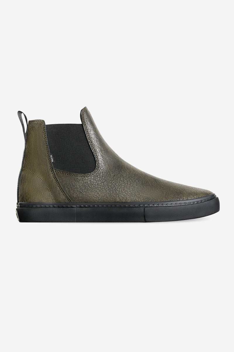 Side view of Dover II Distressed Leather high top slip on boot in olive cracked leather with black sole