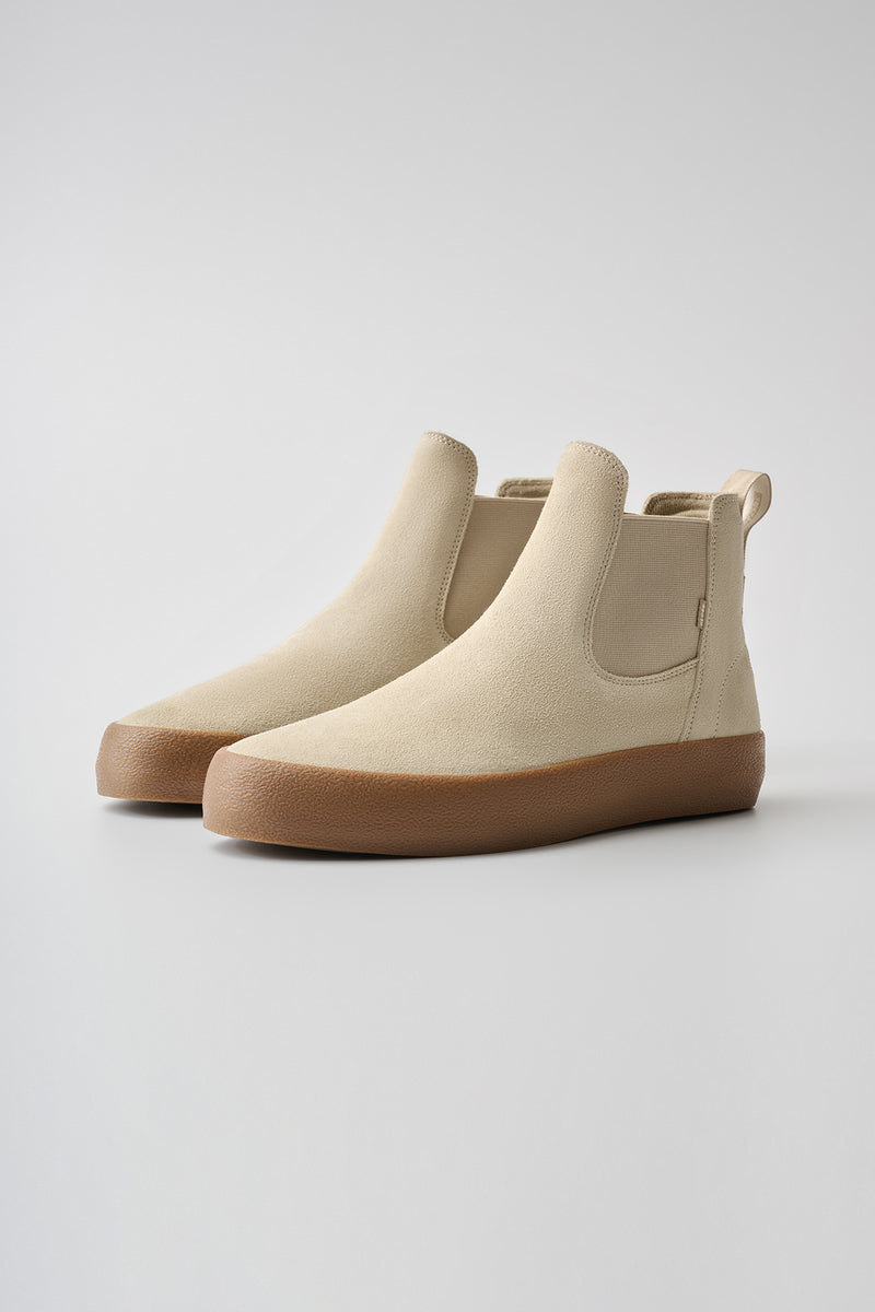 Beige Dover II Safari Crepe slip on skate boot with tan gum sole, angled side view