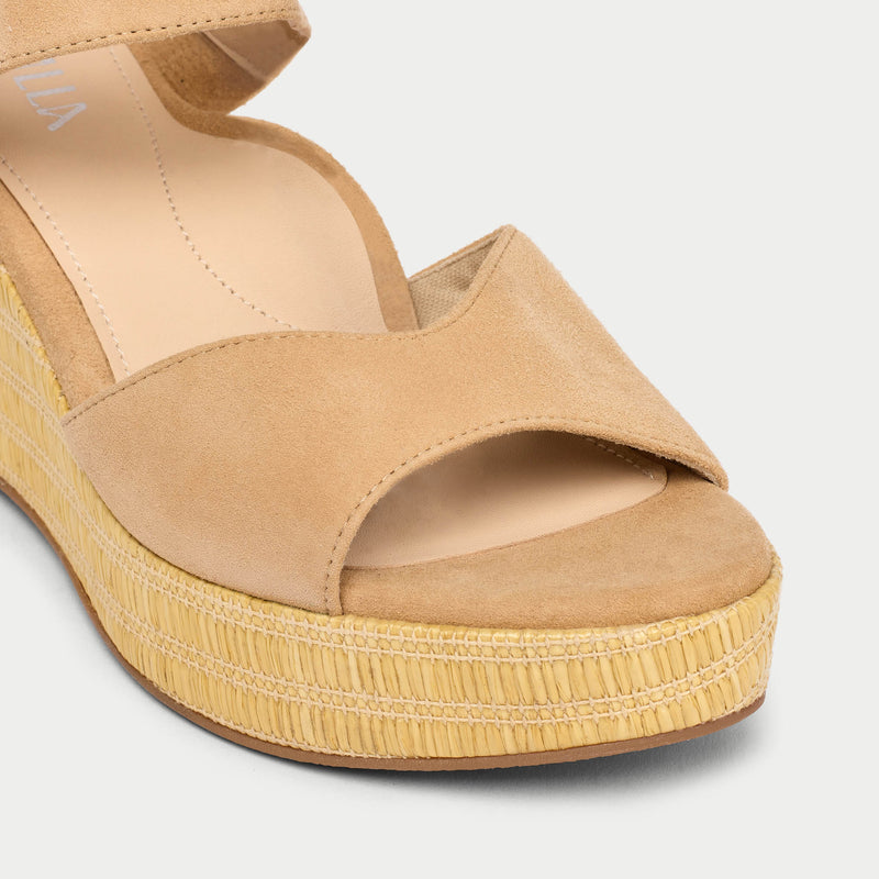 Tan wedge sandal on a white background