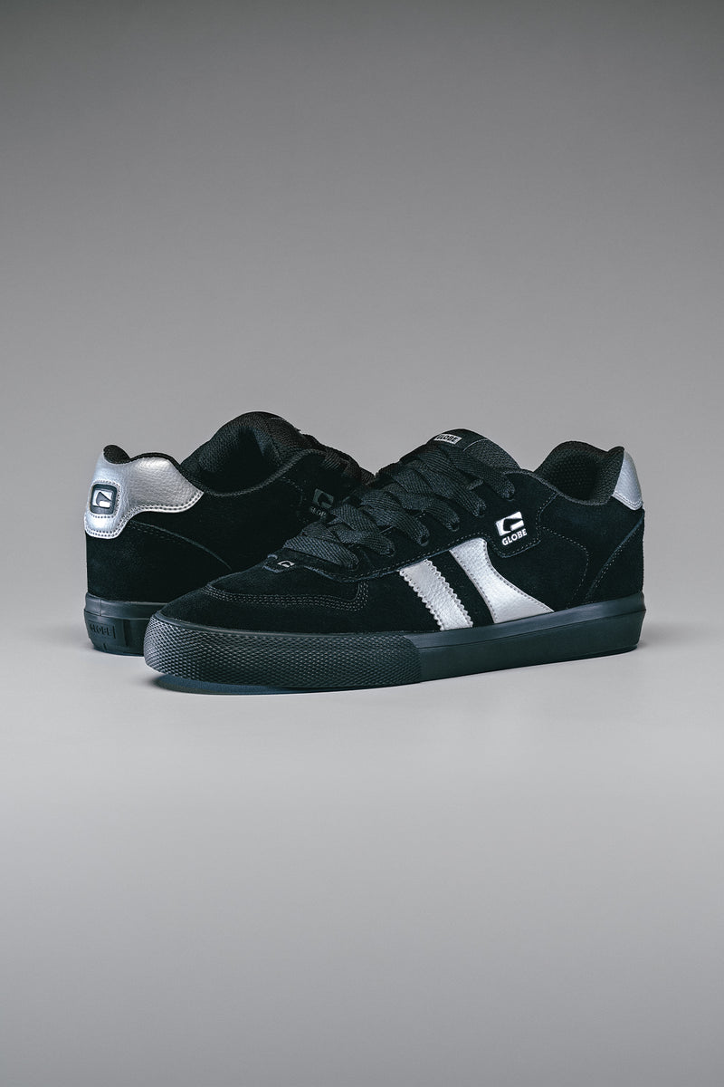 Side view of Encore-2 Black/Metallic Silver sneakers with twin white stripes and Globe logo.