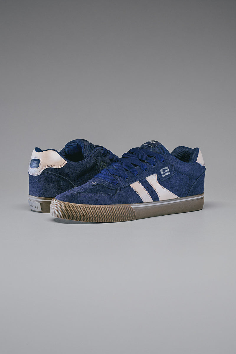 Side view of a pair of Encore-2 Dark Blue skate shoes with white twin stripes and tan soles