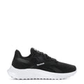 Youth black sneakers with white sole, Reebok logo on side