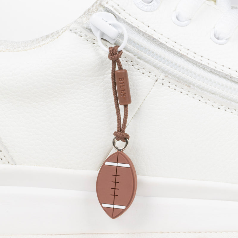 Brown football-shaped zipper pull attached to a white sneaker