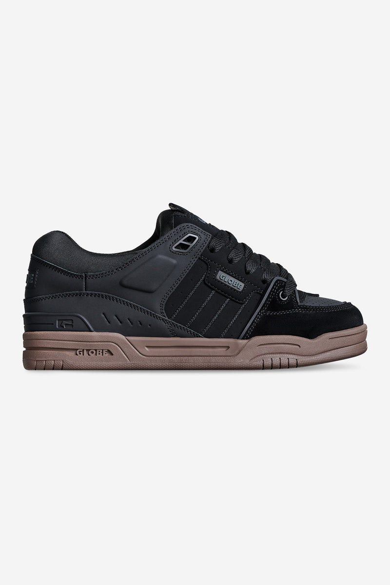 Side profile of Fusion skate shoe in black with tan gum cup sole and padded upper