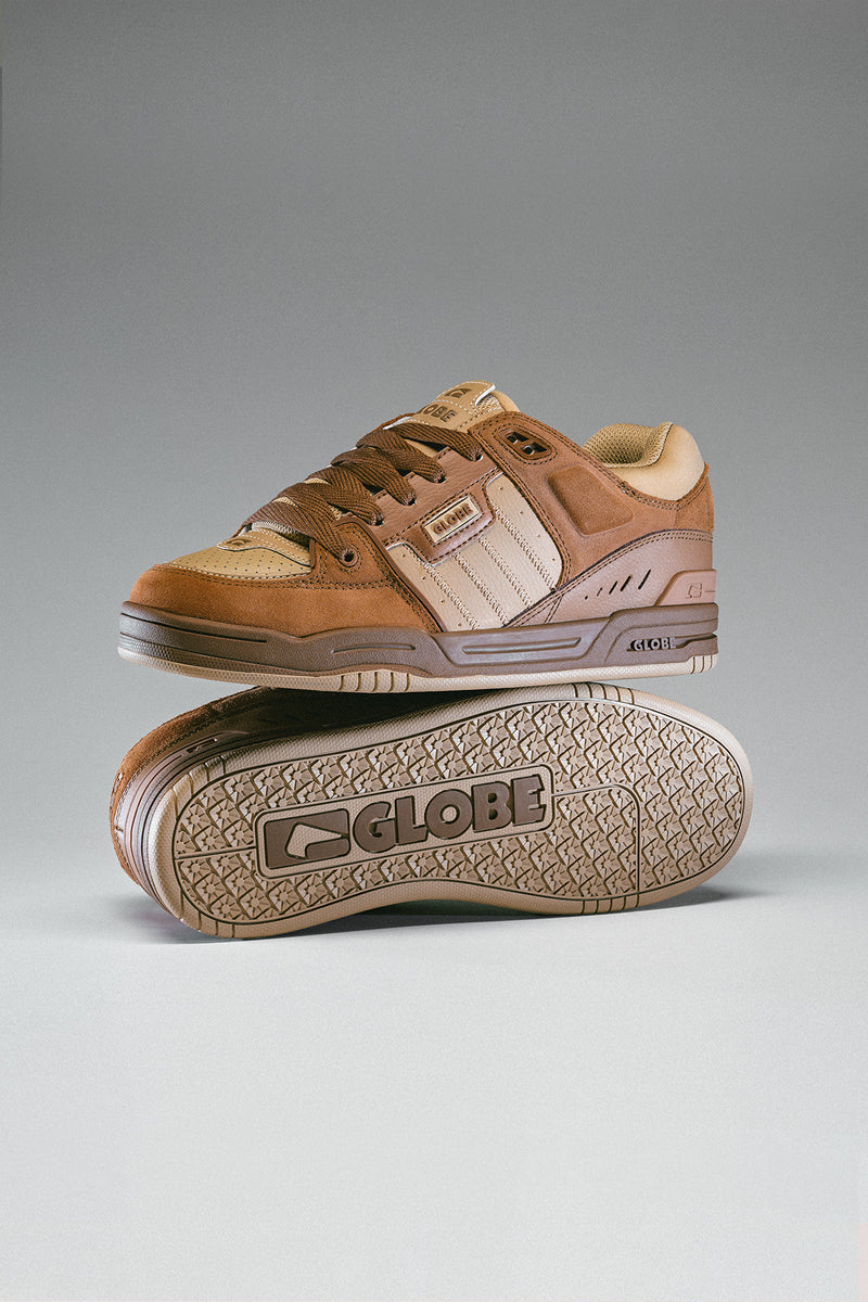 Side angled shot of Fusion Walnut skate shoe showing suede panels and rugged midsole against a gray studio backdrop