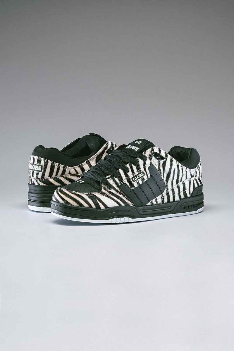Side view of zebra print Fusion sneakers with black laces and beige panels.