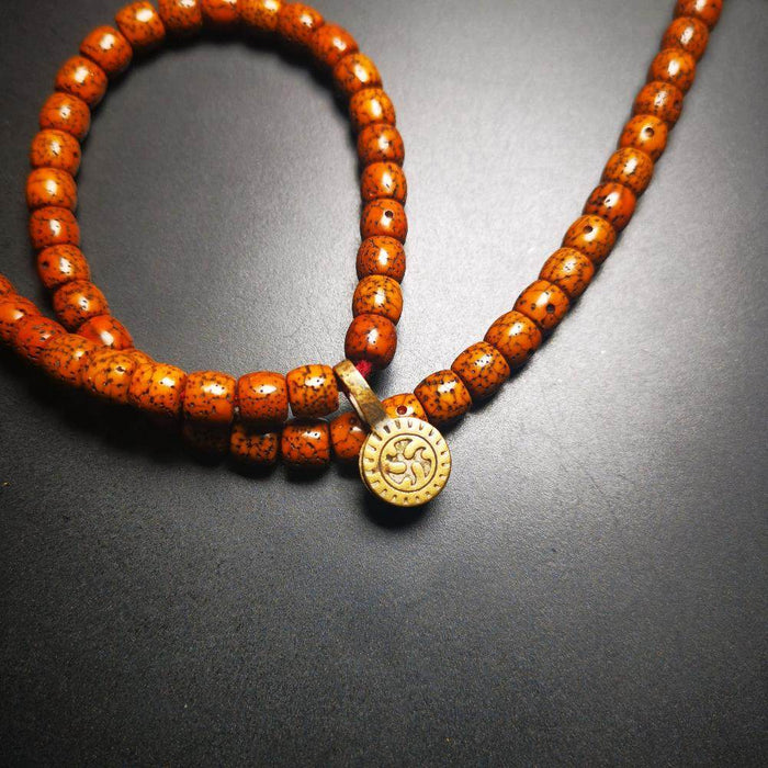 Gandhanra Old Tibetan Buddhist Mala Counter Clip for Prayer Beads,Dharmachakra / - Tibetan Buddhist mala beads, close-up detail