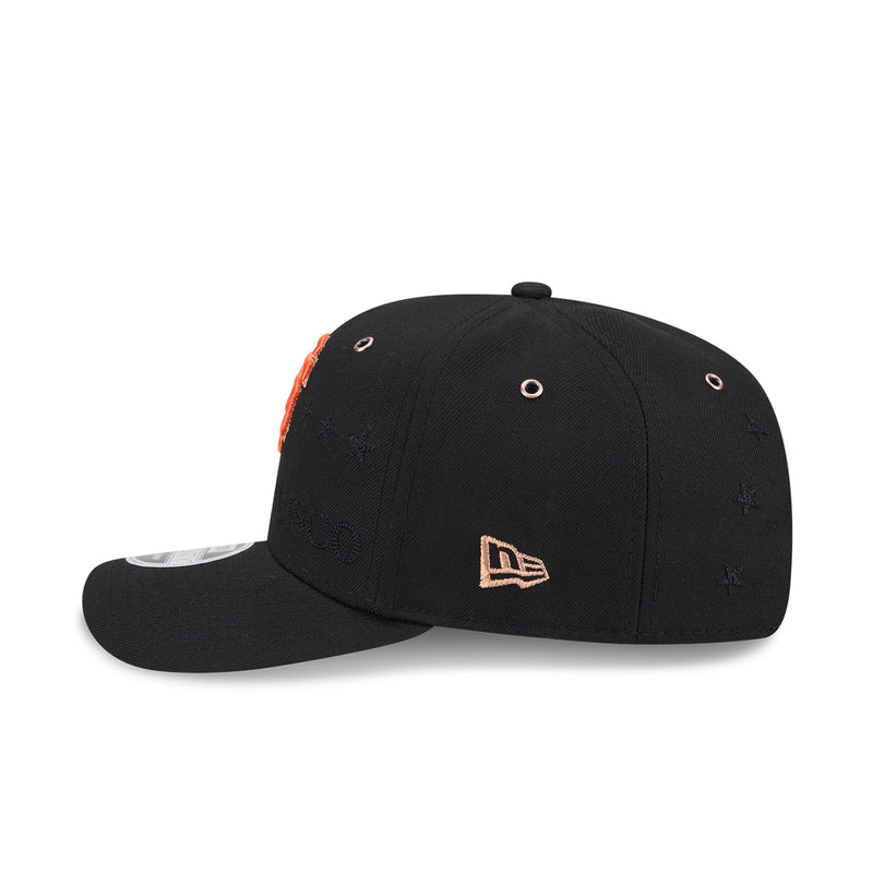 Black baseball cap with New Era logo patch and orange stitching detail.