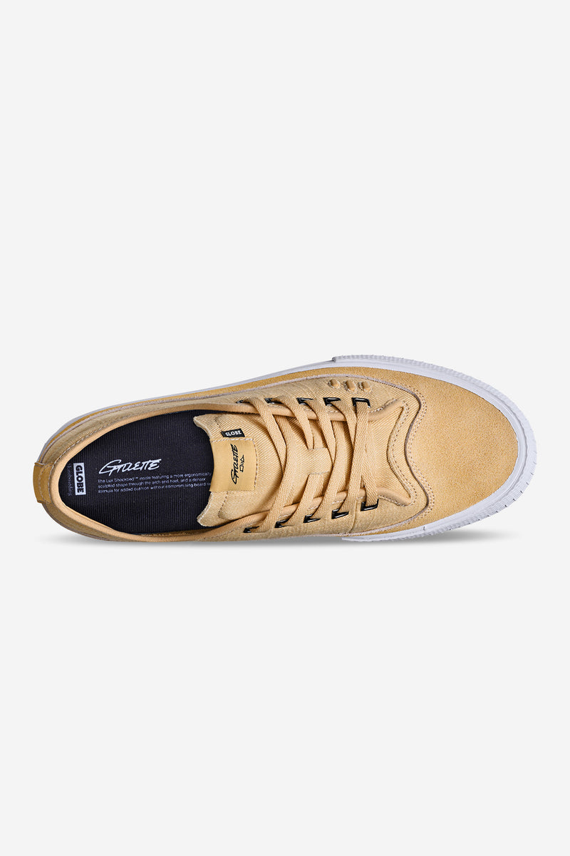 Top view of khaki suede Globe skate shoe with lace-up design and branded tongue patch.