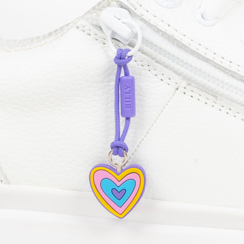 Heart-shaped zipper pull with colorful design on a white shoe