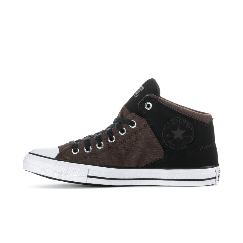 Side view of mid-top sneakers in brown and black with lace-up eyelets and star patch