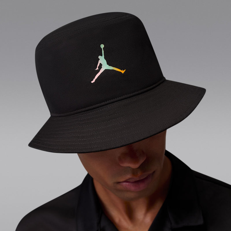Black bucket hat with multicolor Jumpman logo, front-left angle on model.