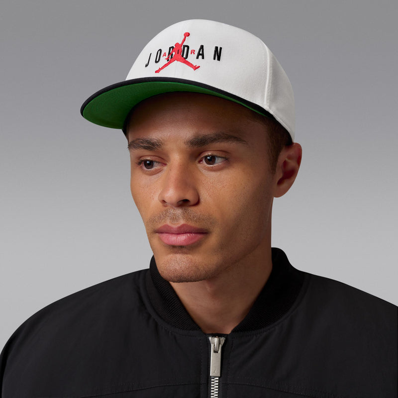 White snapback cap with red Jumpman and black Jordan text on model