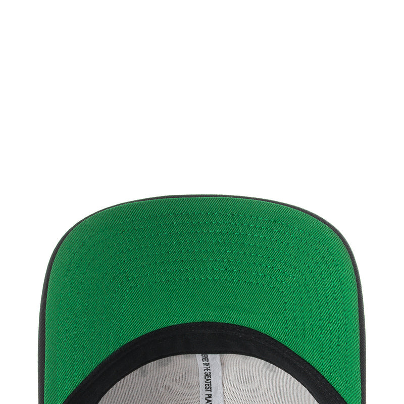 Green fabric panel with black trim, close-up of snapback cap edge