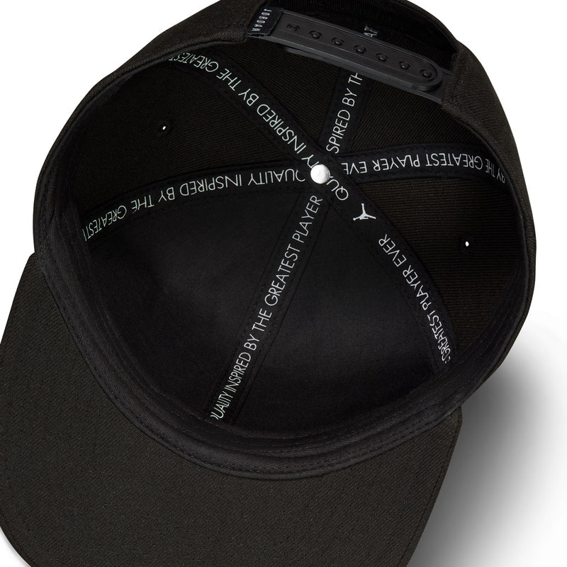 Black cap underside with branding print and snapback adjustment hardware