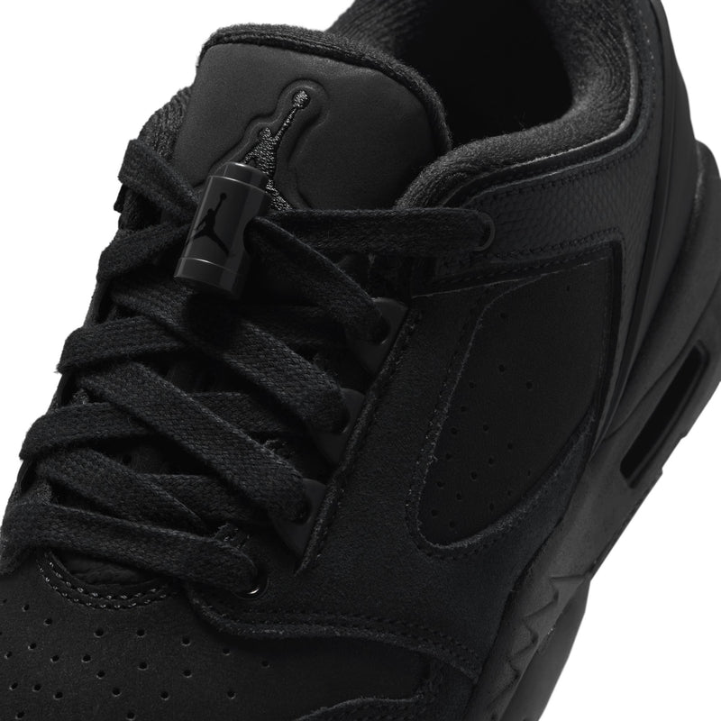 Close-up of black youth sneaker upper with lace eyelets and padded tongue