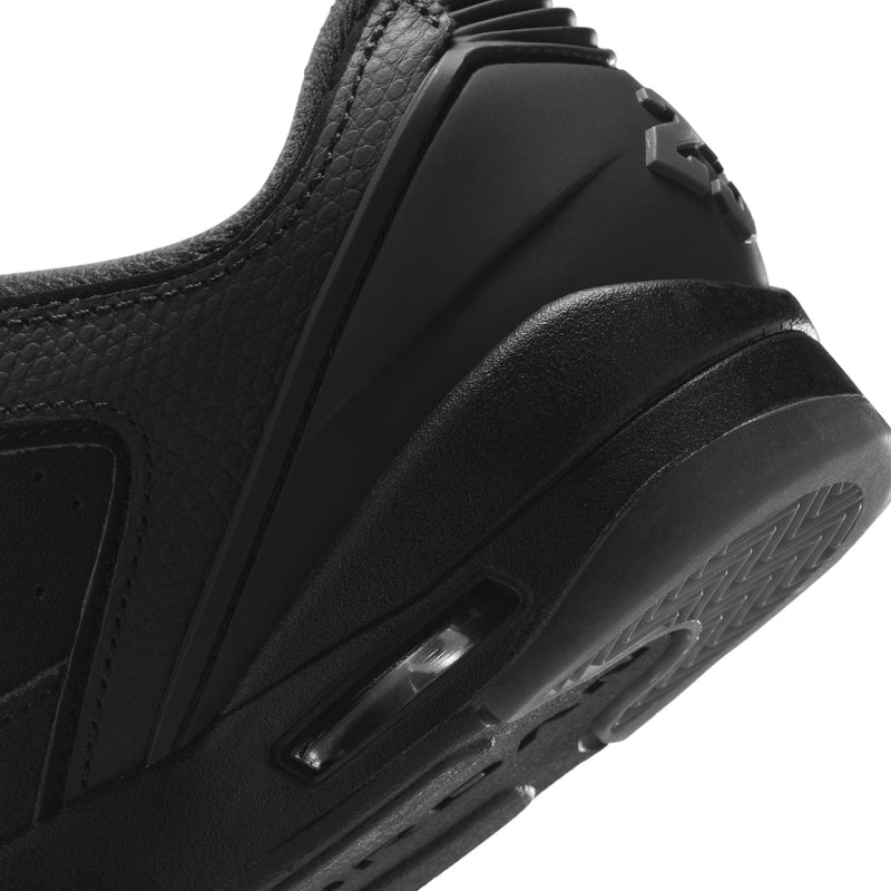 Close-up of black youth sneaker side with Air-like window detail on midsole