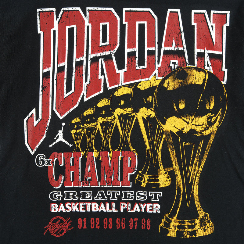 Youth black Jumpman graphic T-shirt with large red Jumpman text and gold trophy