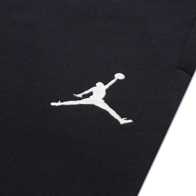 Black fabric jogger pant leg with white Jumpman logo