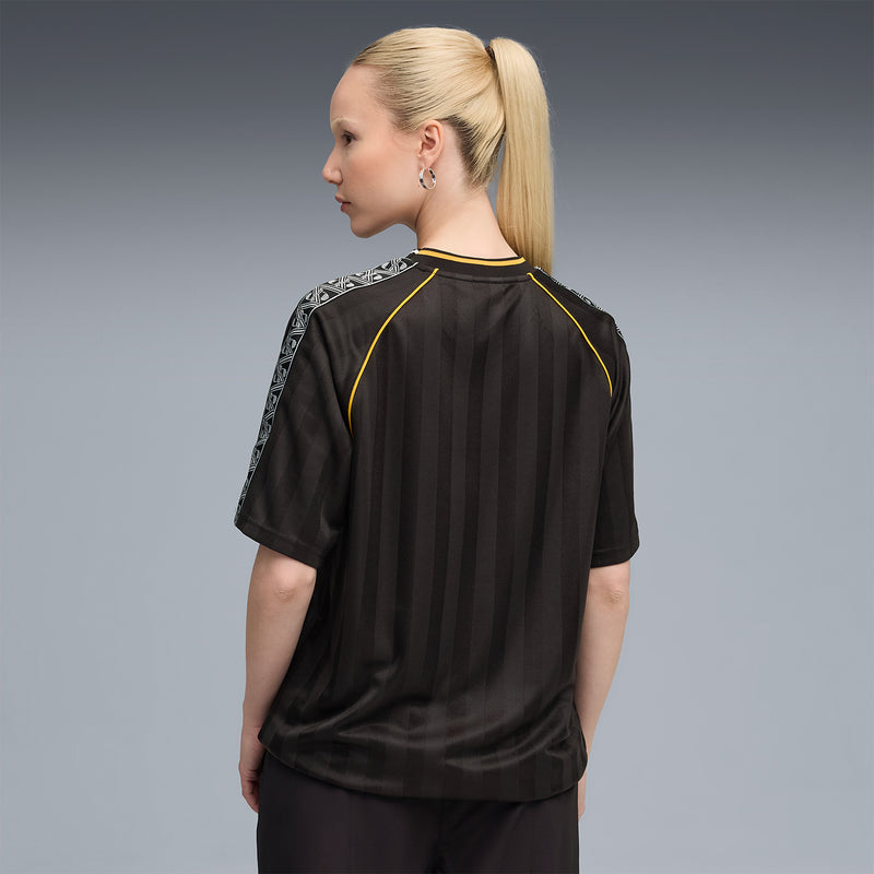 Black soccer jersey back with yellow piping and patterned sleeve panels
