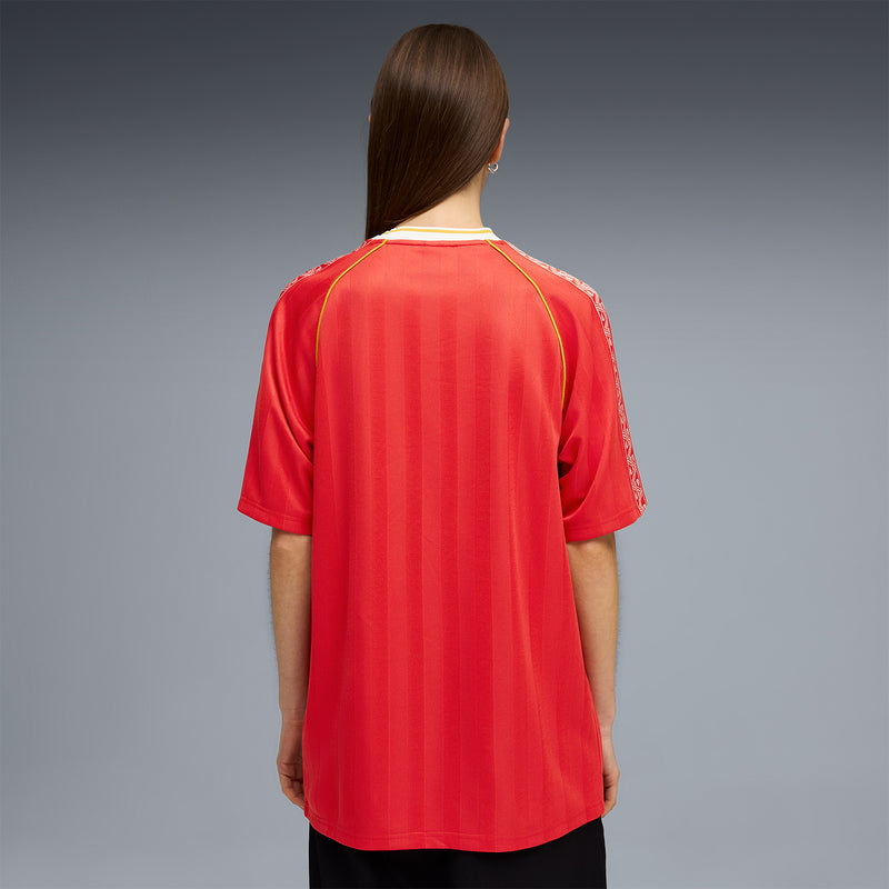 Red soccer jersey back view with yellow piping along the seams