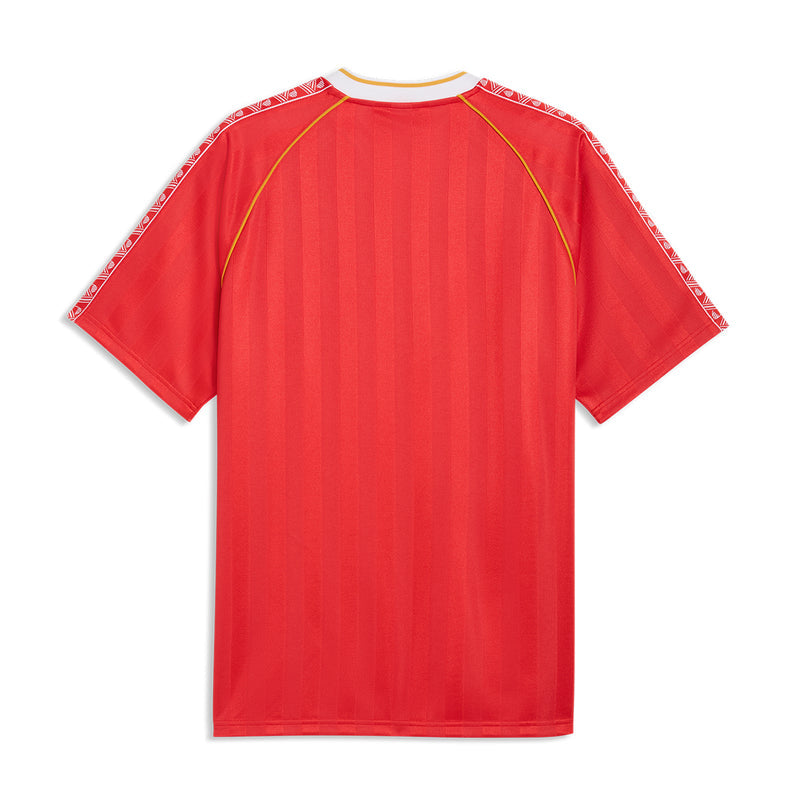 Red soccer jersey back with patterned shoulder trim and yellow seam piping