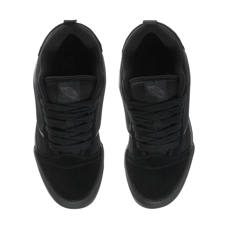 Pair of black low-top sneakers with lace-up vamp and padded tongue